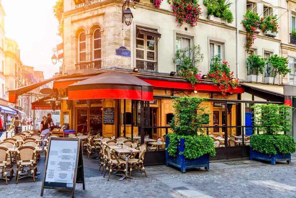 Cozy street with tables of cafe bistro in Paris, France