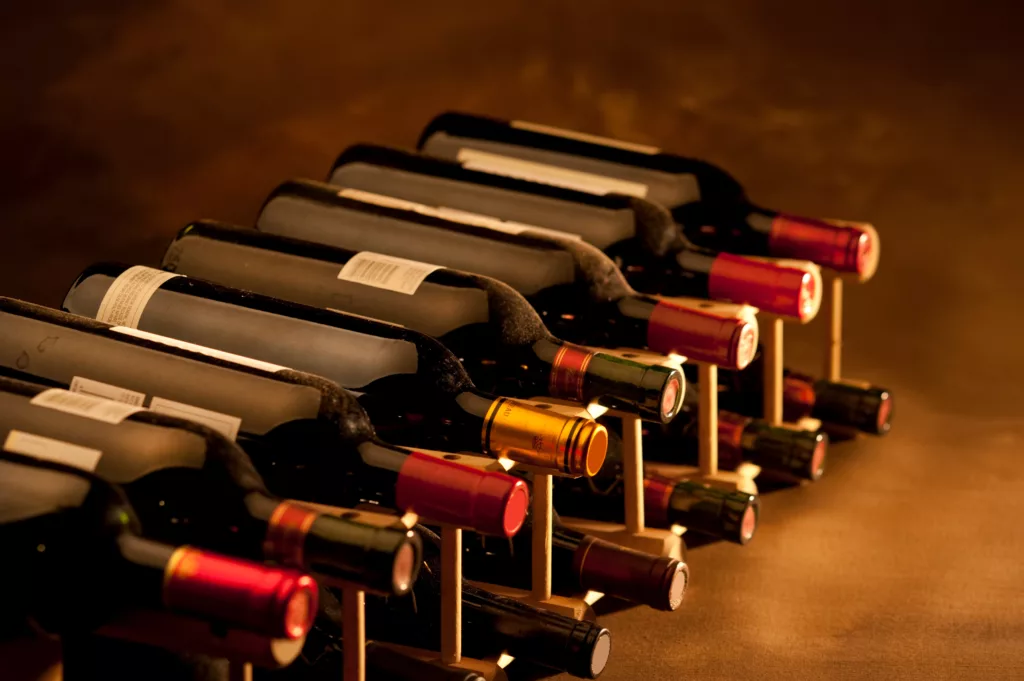 Red wine bottles in rack at Parisian Cave